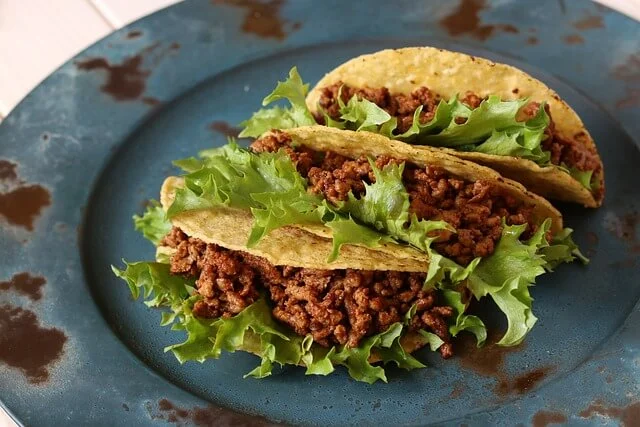 Assembling the grilled steak elote tacos